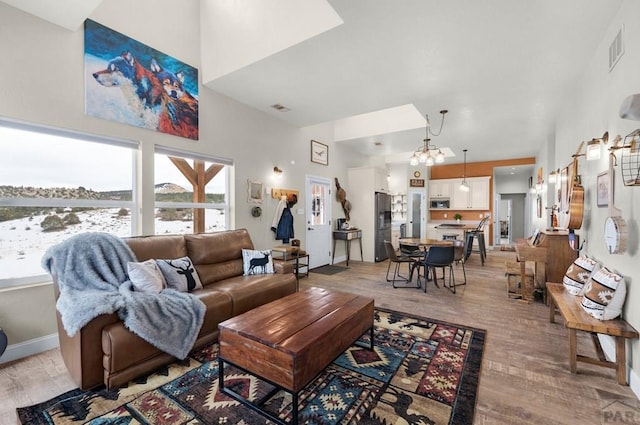 311 Knickerbocker Rd, Silver Cliff, CO 81252 - living area with light wood finished floors, a chandelier, and a high ceiling