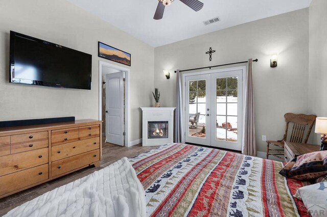 311 Knickerbocker Rd, Silver Cliff, CO 81252 - bedroom with access to exterior, french doors, wood finished floors, baseboards, and ceiling fan