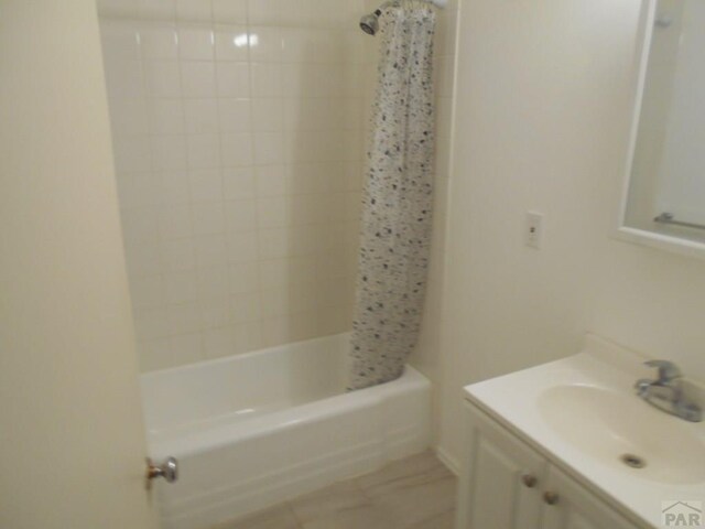 bathroom featuring shower / bath combo and vanity