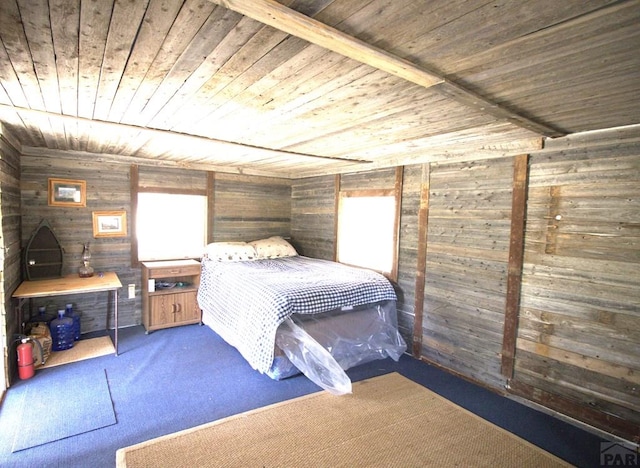 carpeted bedroom with wood ceiling and wooden walls