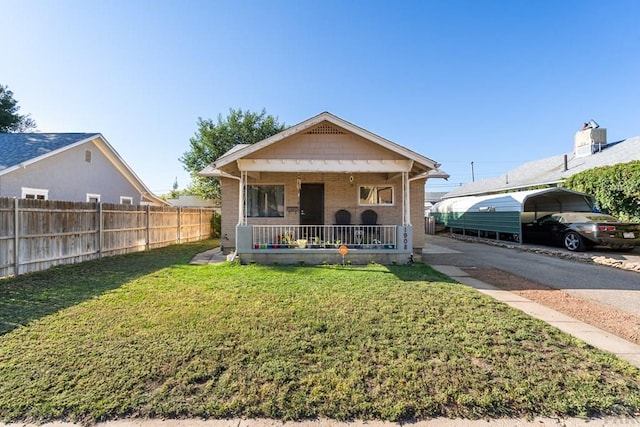 1908 E 5th St, Pueblo, CO 81001 - view of front of home with covered porch, brick siding, and a detached carport