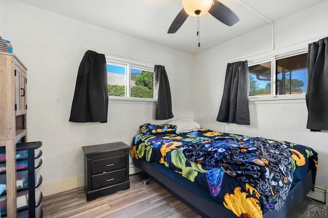 1908 E 5th St, Pueblo, CO 81001 - bedroom with wood finished floors, baseboards, and ceiling fan