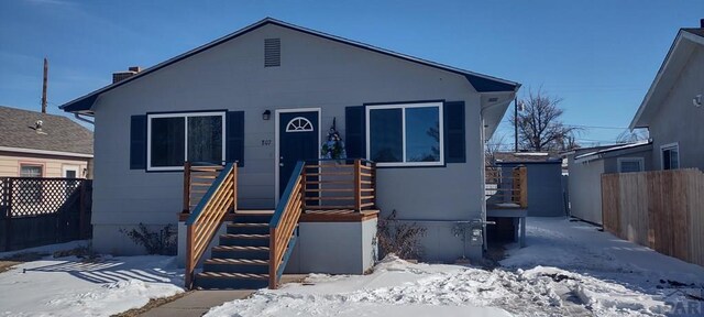 bungalow-style home featuring fence