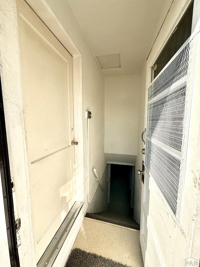 stairs featuring attic access