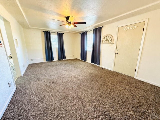 interior space with carpet, ceiling fan, and a textured ceiling