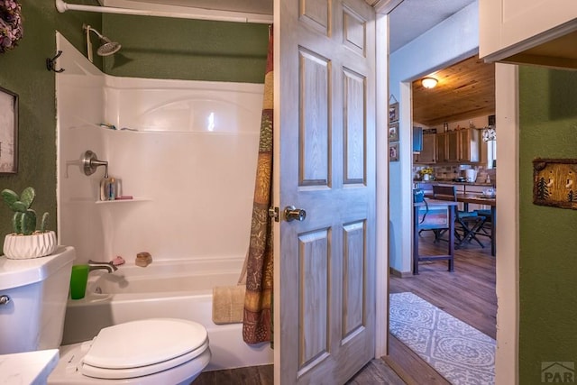 bathroom with toilet, tasteful backsplash, wood finished floors, and shower / bathing tub combination