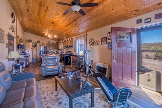 living area featuring heating unit, lofted ceiling, a ceiling fan, wood finished floors, and wooden ceiling