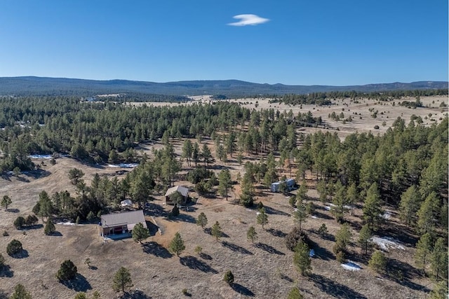 aerial view with a mountain view and a view of trees