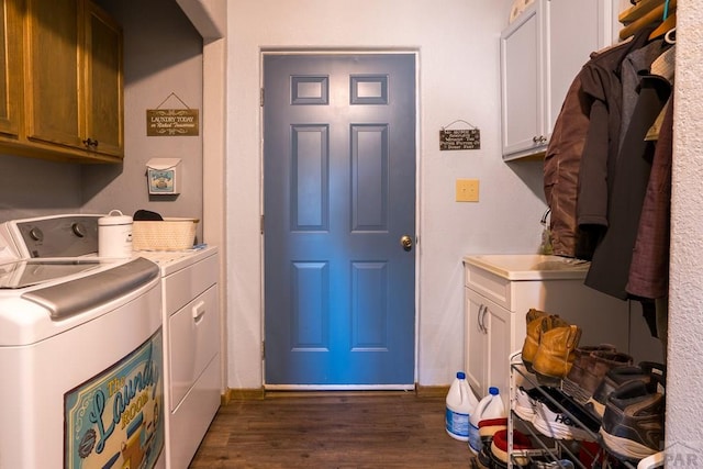 laundry room with cabinet space, baseboards, separate washer and dryer, and dark wood finished floors