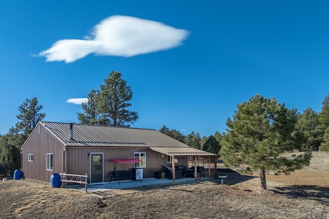 exterior space with metal roof and a patio area