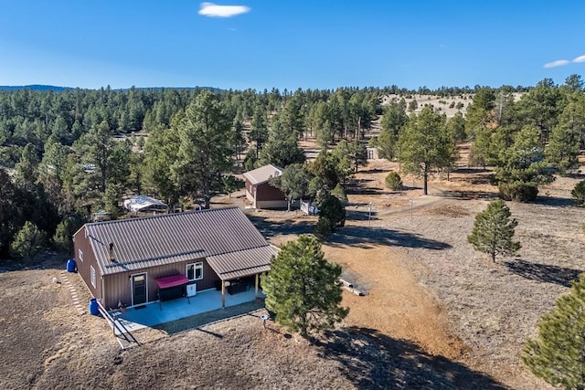 aerial view featuring a wooded view