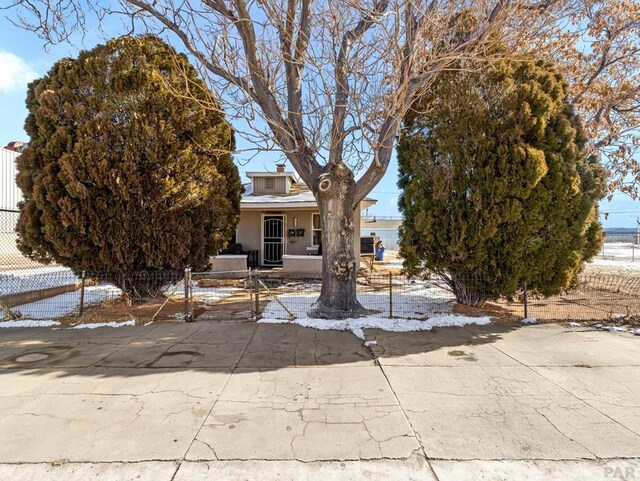 obstructed view of property featuring fence and stucco siding