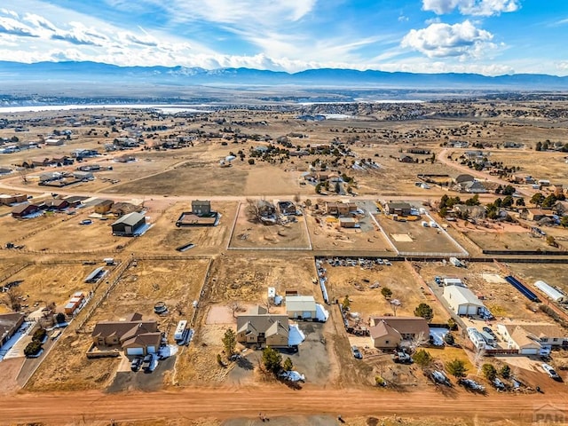 birds eye view of property featuring view of desert and a mountain view