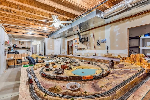 game room featuring concrete flooring and ceiling fan