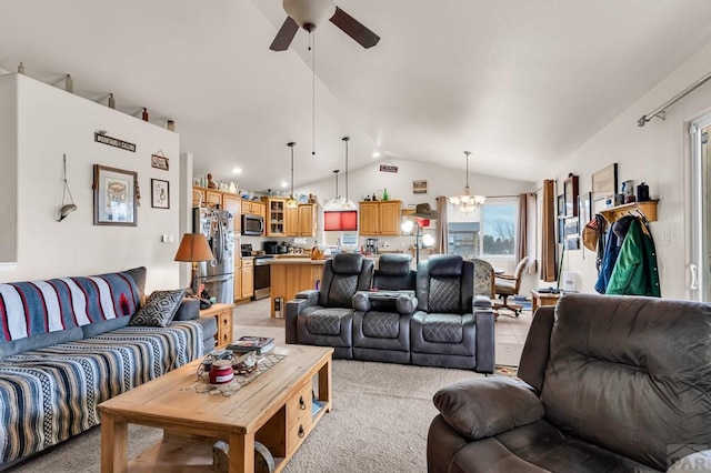 living area with light colored carpet, vaulted ceiling, and ceiling fan with notable chandelier