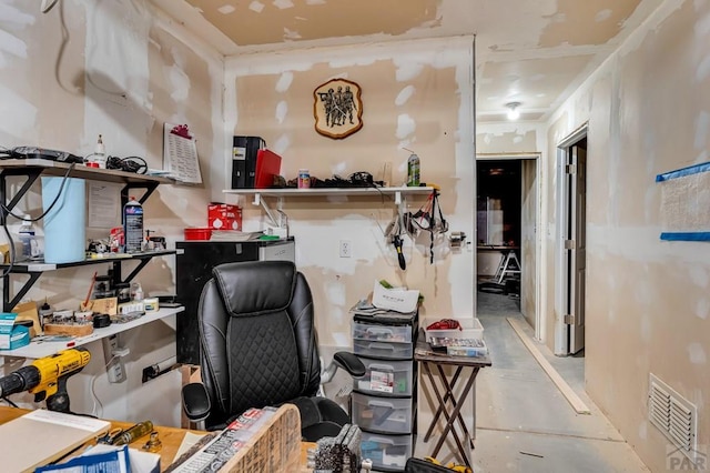 office with a workshop area, concrete floors, and visible vents