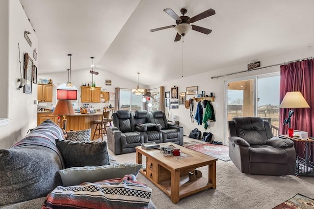 living room with lofted ceiling, ceiling fan with notable chandelier, and light colored carpet