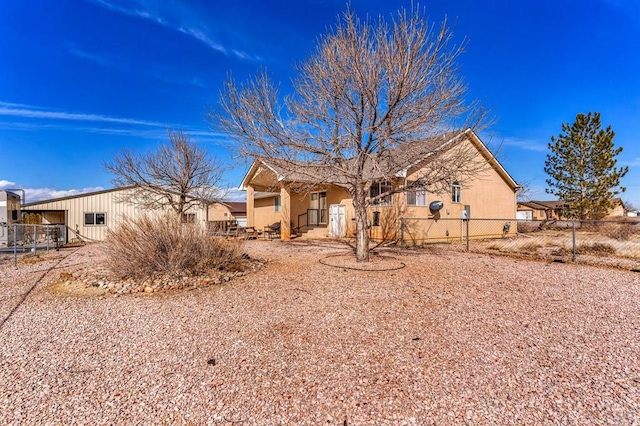 view of front of home featuring fence