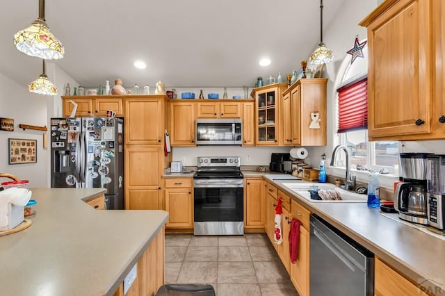 kitchen featuring stainless steel appliances, light countertops, and glass insert cabinets