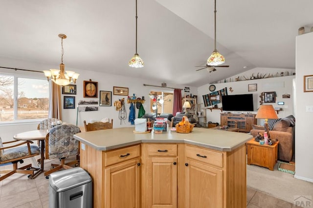 kitchen featuring a center island, lofted ceiling, light countertops, light brown cabinetry, and open floor plan