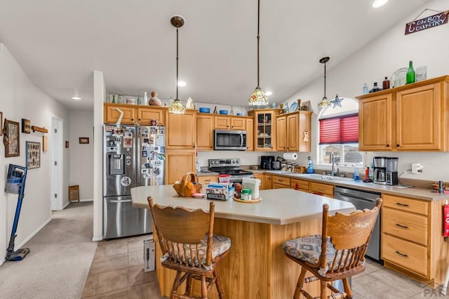 kitchen with stainless steel appliances, a sink, light countertops, a center island, and glass insert cabinets