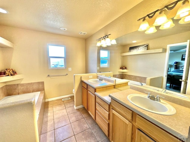 full bathroom featuring ensuite bath, visible vents, a sink, and tile patterned floors