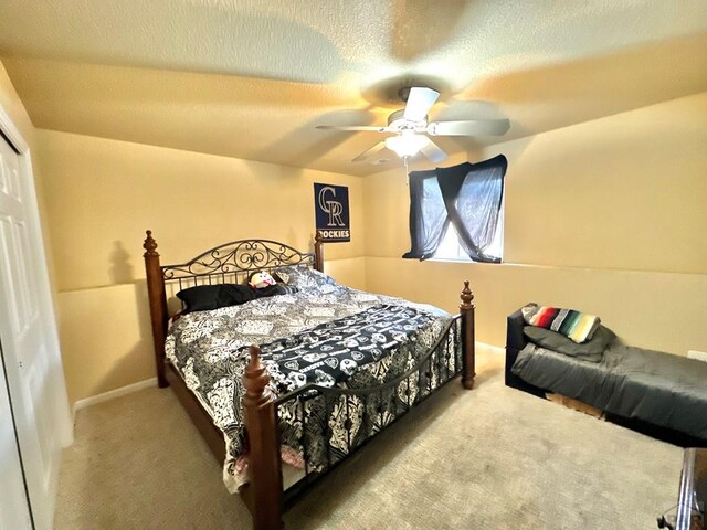 carpeted bedroom featuring a textured ceiling, ceiling fan, and a closet