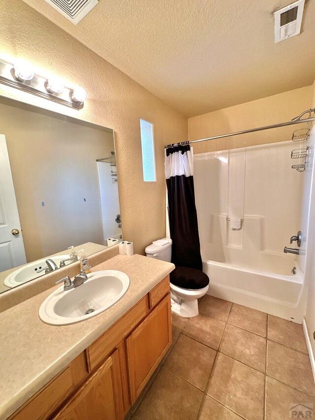 full bath featuring tile patterned flooring, visible vents, a textured ceiling, and toilet