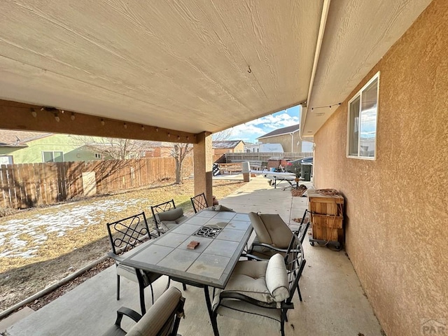 view of patio with outdoor dining space and a fenced backyard