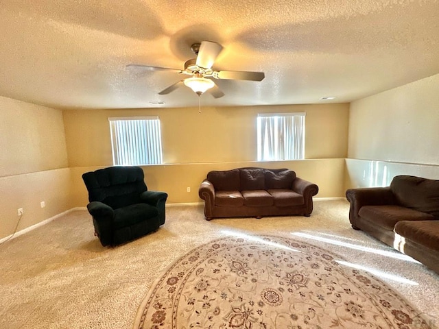 living room featuring ceiling fan, carpet, and baseboards