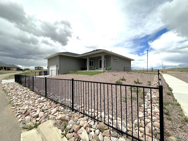 4805 Walking Stick Blvd, Pueblo, CO 81001 - view of front of house featuring a garage and stucco siding