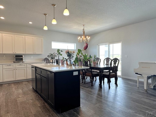 4805 Walking Stick Blvd, Pueblo, CO 81001 - kitchen featuring a sink, light countertops, dark wood finished floors, a chandelier, and dishwasher