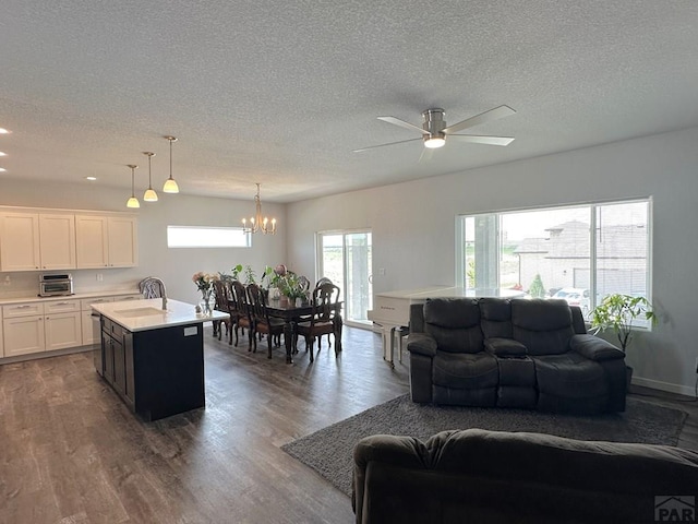 4805 Walking Stick Blvd, Pueblo, CO 81001 - living room with healthy amount of natural light, a textured ceiling, a chandelier, dark wood-style flooring, and a ceiling fan