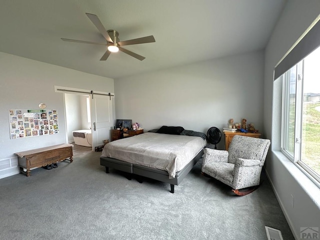 4805 Walking Stick Blvd, Pueblo, CO 81001 - bedroom with carpet flooring, a barn door, baseboards, and ceiling fan