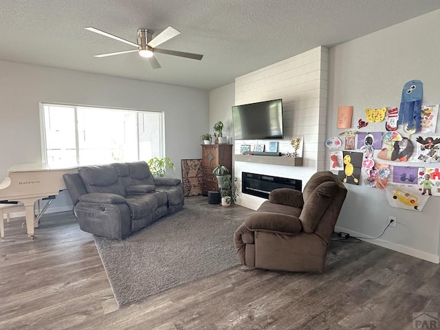 4805 Walking Stick Blvd, Pueblo, CO 81001 - living area with wood finished floors, a ceiling fan, a textured ceiling, and a glass covered fireplace
