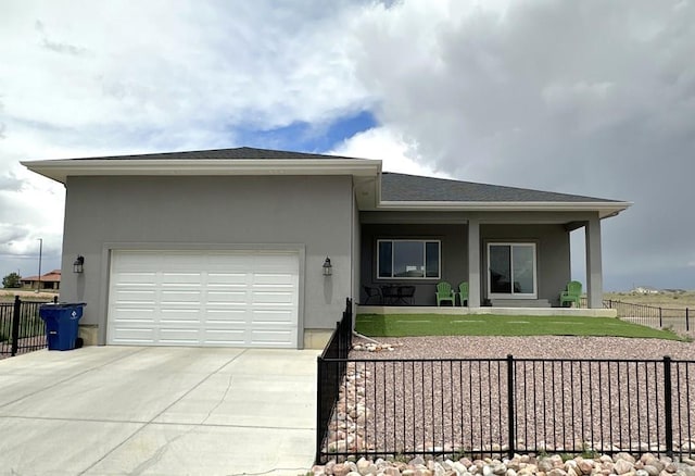 4805 Walking Stick Blvd, Pueblo, CO 81001 - view of front of home featuring stucco siding, a garage, and concrete driveway