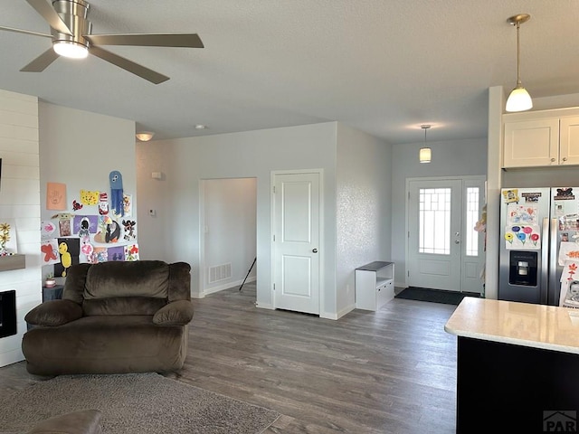 4805 Walking Stick Blvd, Pueblo, CO 81001 - living area featuring dark wood finished floors, baseboards, and a ceiling fan