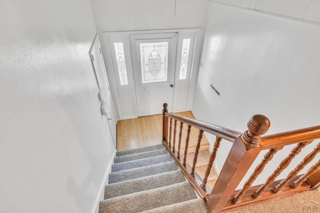 stairs with wood finished floors