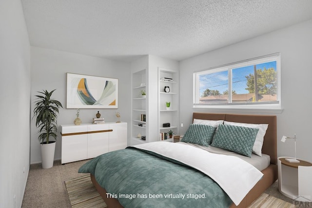 bedroom featuring light colored carpet and a textured ceiling