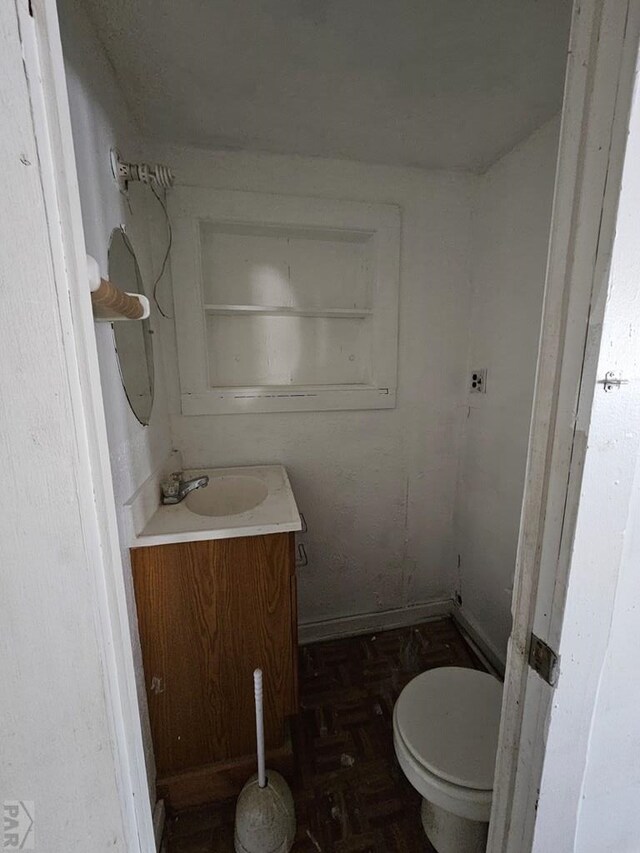 half bathroom with toilet and vanity