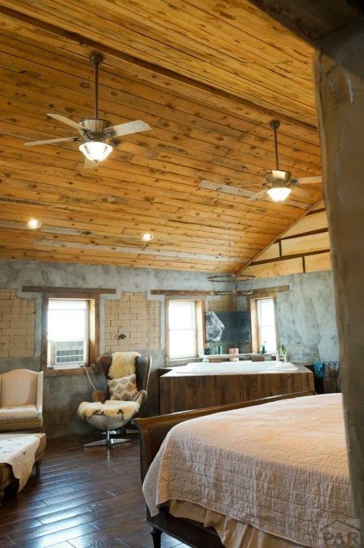 bedroom featuring vaulted ceiling, cooling unit, wood finished floors, and wood ceiling