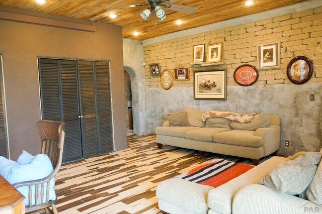 living room featuring arched walkways, wood ceiling, ceiling fan, and recessed lighting