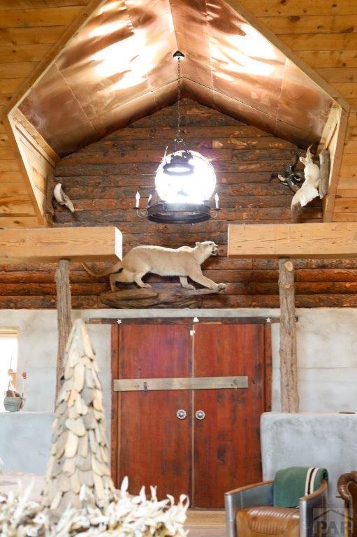 interior space featuring lofted ceiling and wooden ceiling