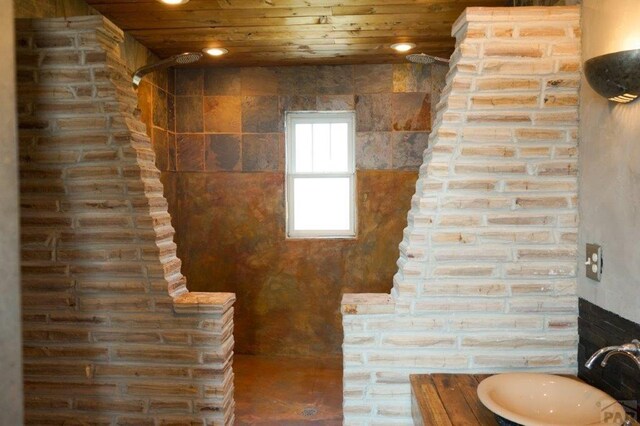 bathroom with walk in shower, a sink, wood ceiling, and recessed lighting