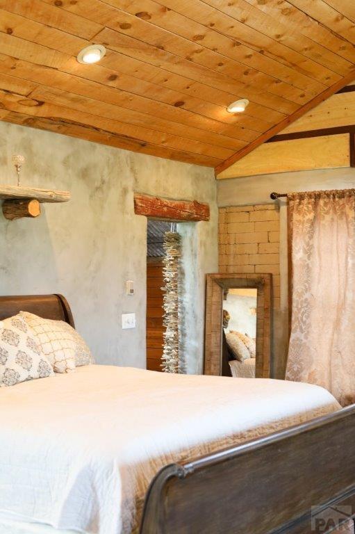 bedroom featuring lofted ceiling and wooden ceiling