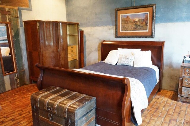 bedroom featuring brick floor