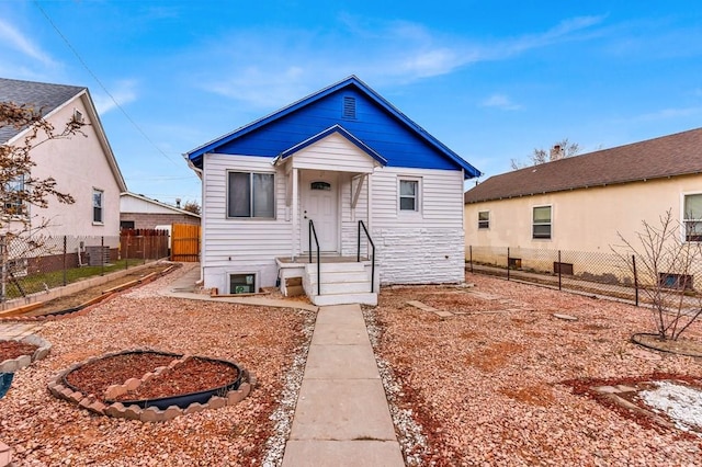 bungalow-style home featuring fence