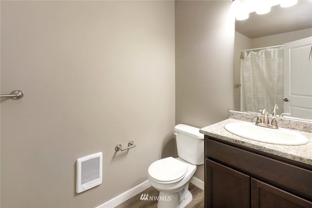 bathroom featuring hardwood / wood-style floors, toilet, and large vanity