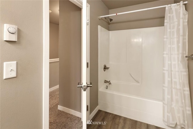 bathroom with shower / bath combo and hardwood / wood-style floors